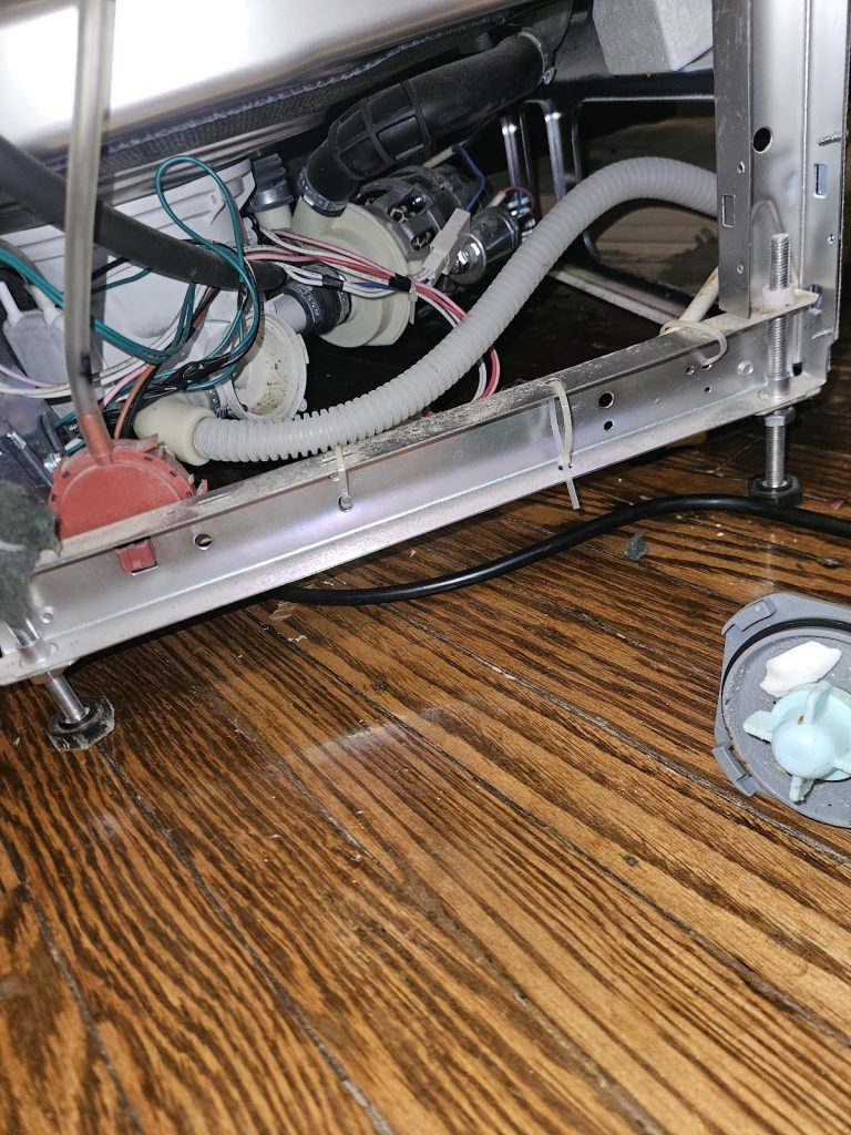 Dishwasher pulled out with the base exposed during a repair by Octopus Royal