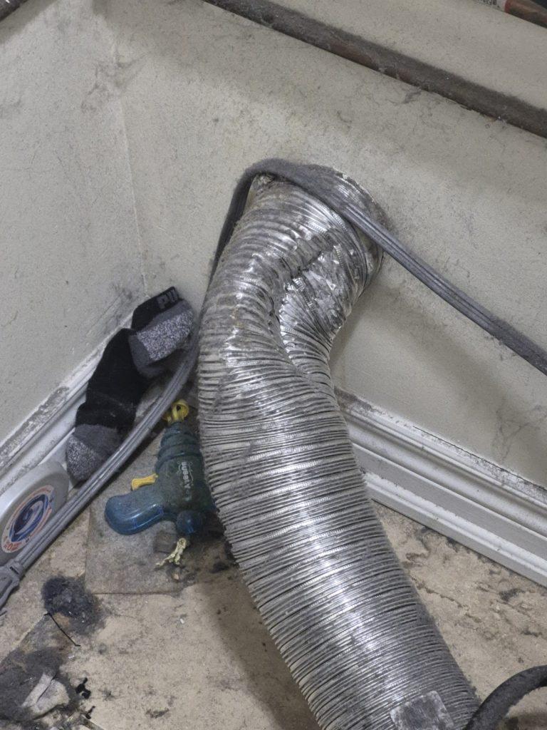 Dryer vent duct behind a dryer, checked during a dryer repair by Octopus Royal