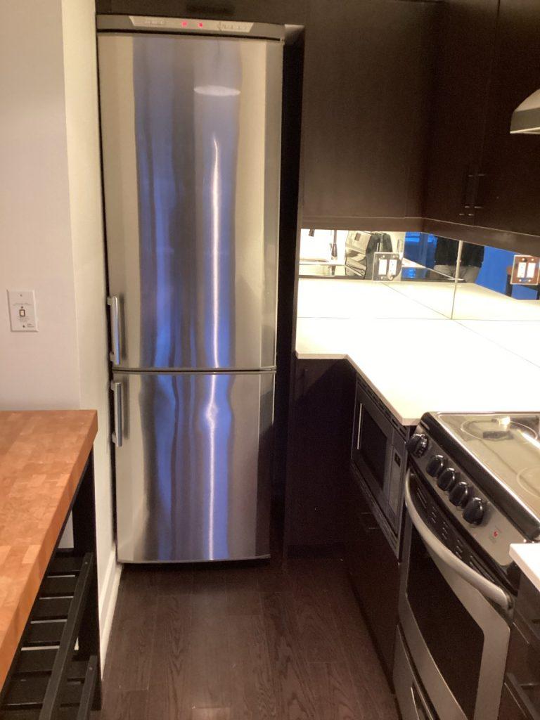 Stainless steel bottom-freezer refrigerator serviced by Octopus Royal