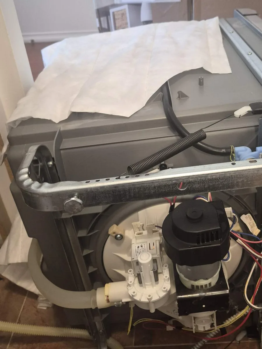 Frigidaire dishwasher pulled out and laid on its back for a drain pump replacement