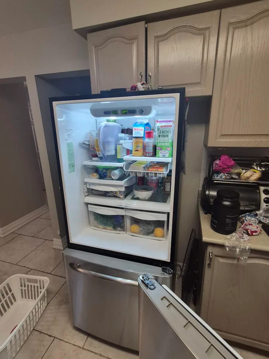 GE bottom-freezer fridge with the fresh-food door removed after the hinge failed, in Richmond Hill