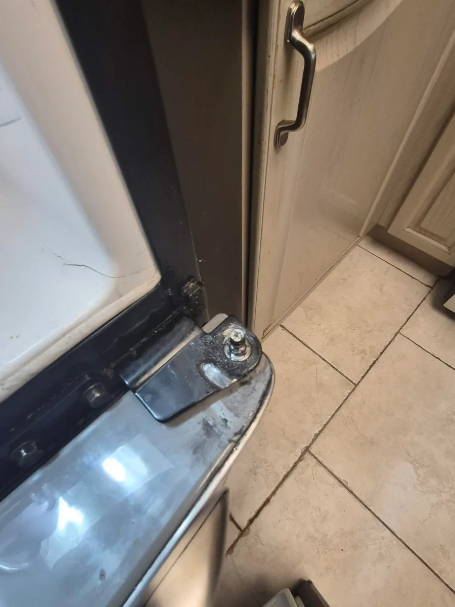 Bottom hinge pin of a GE fridge worn down so the door sags and will not close properly