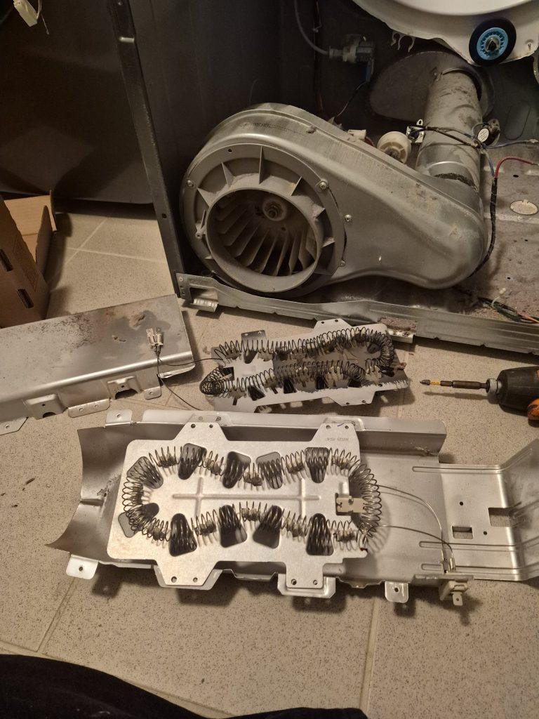 Old burnt Samsung dryer heater element next to the new replacement element, Toronto