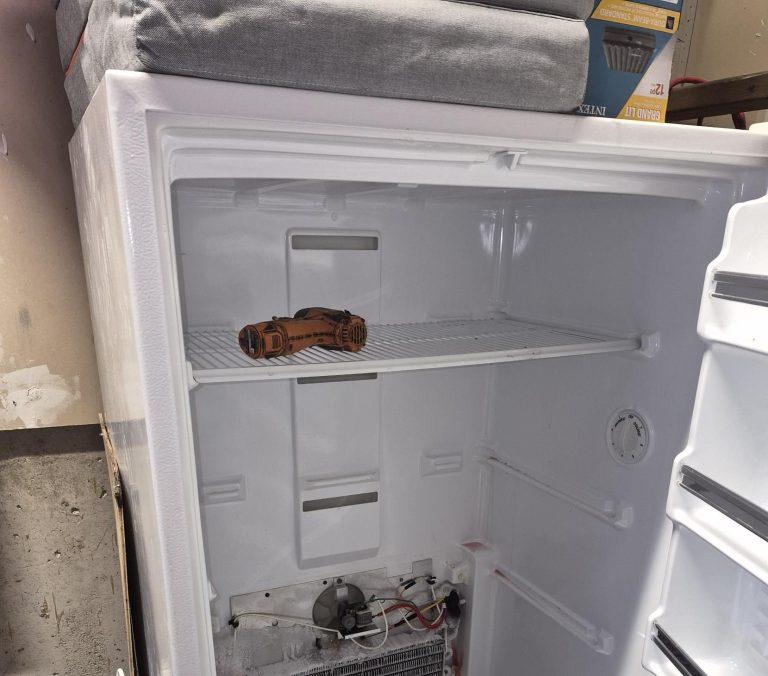 Upright deep freezer opened up for a defrost repair, Vaughan