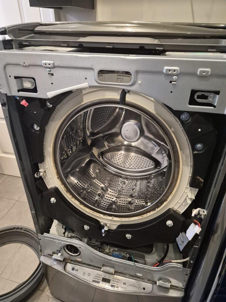 LG washer drum opening with the old door gasket removed, showing grime build-up, North York
