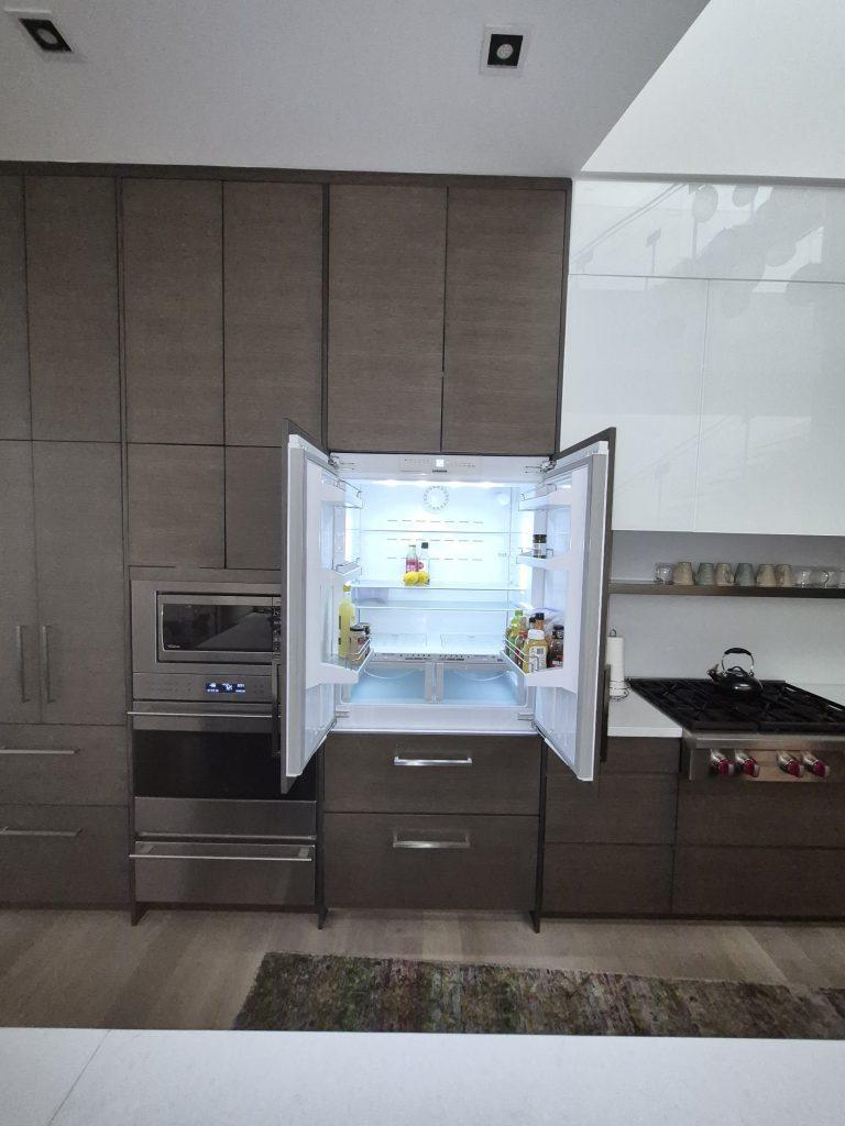Built-in Liebherr French-door fridge with panel-ready doors open, before door alignment in North York