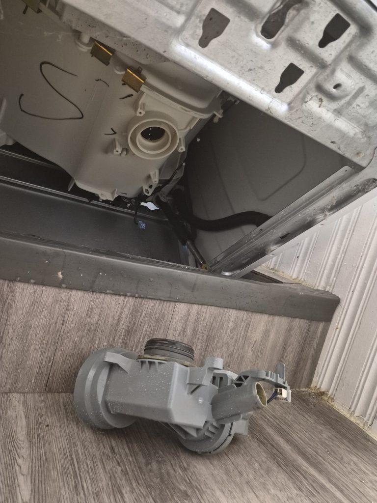 Whirlpool washer tipped back with the drain pump removed during a drain pump replacement in North York