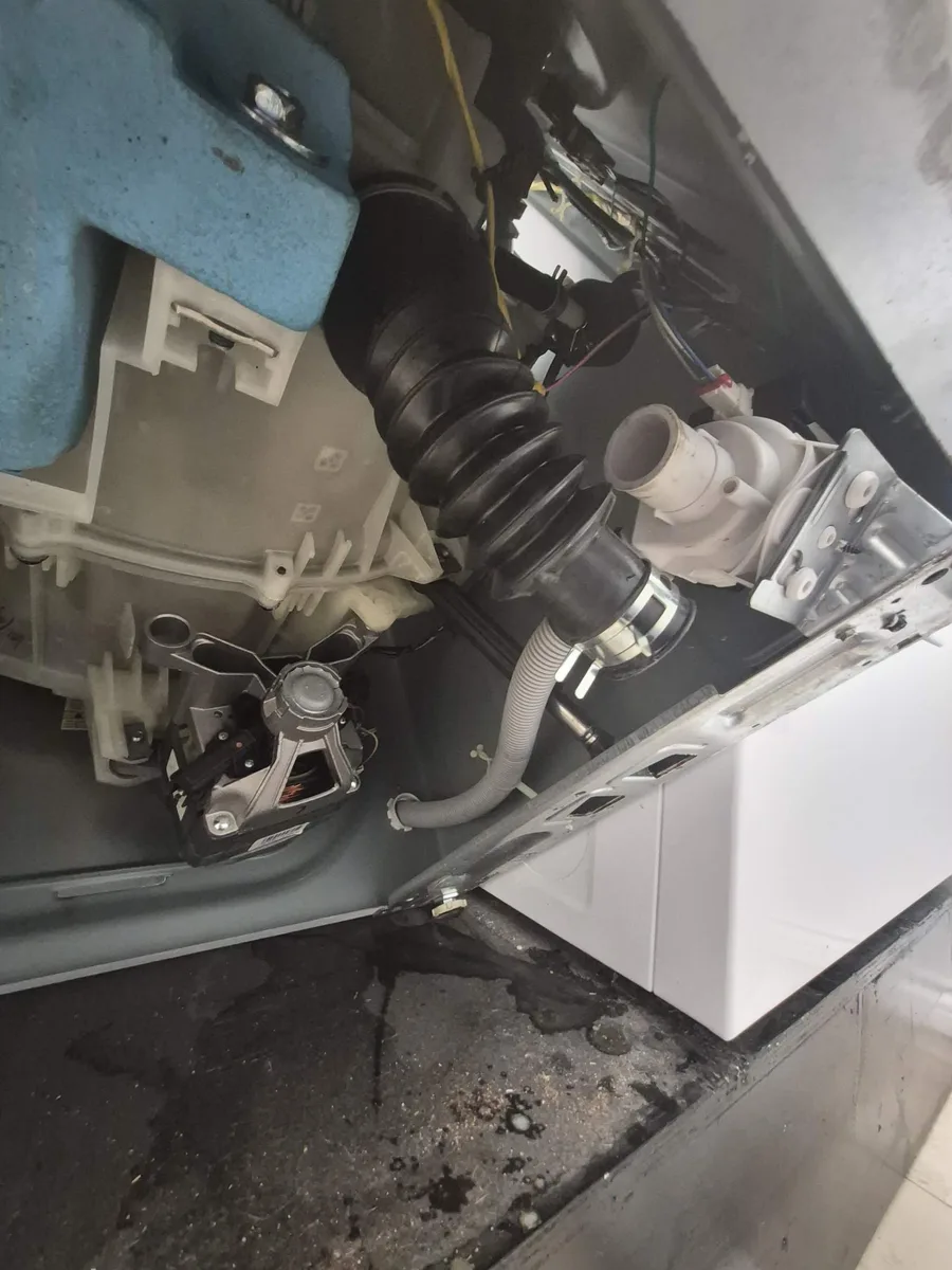 Drain pump area inside a Maytag compact front-load washer during the repair
