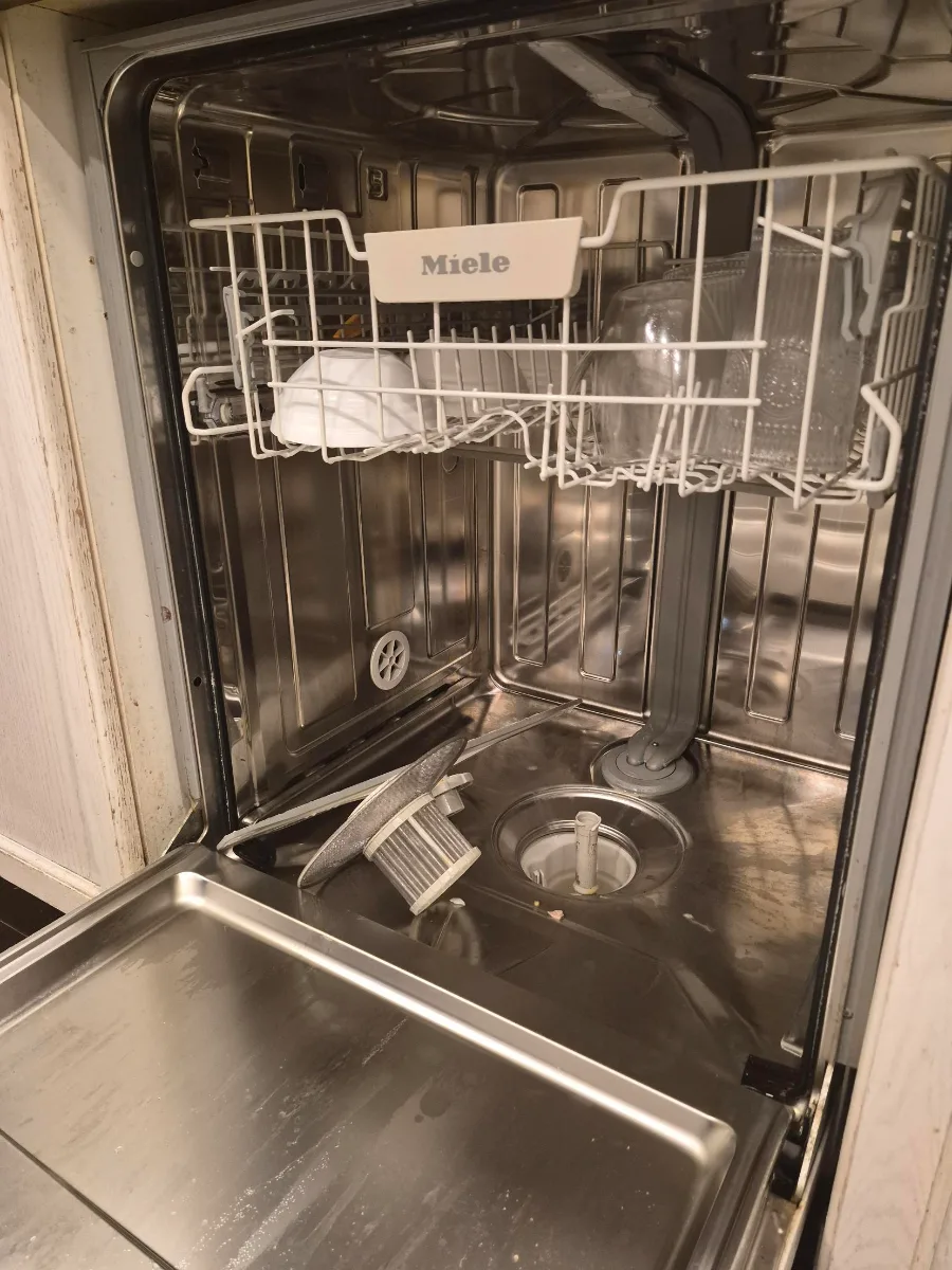 Miele dishwasher with the filter removed to clean the drain pump housing