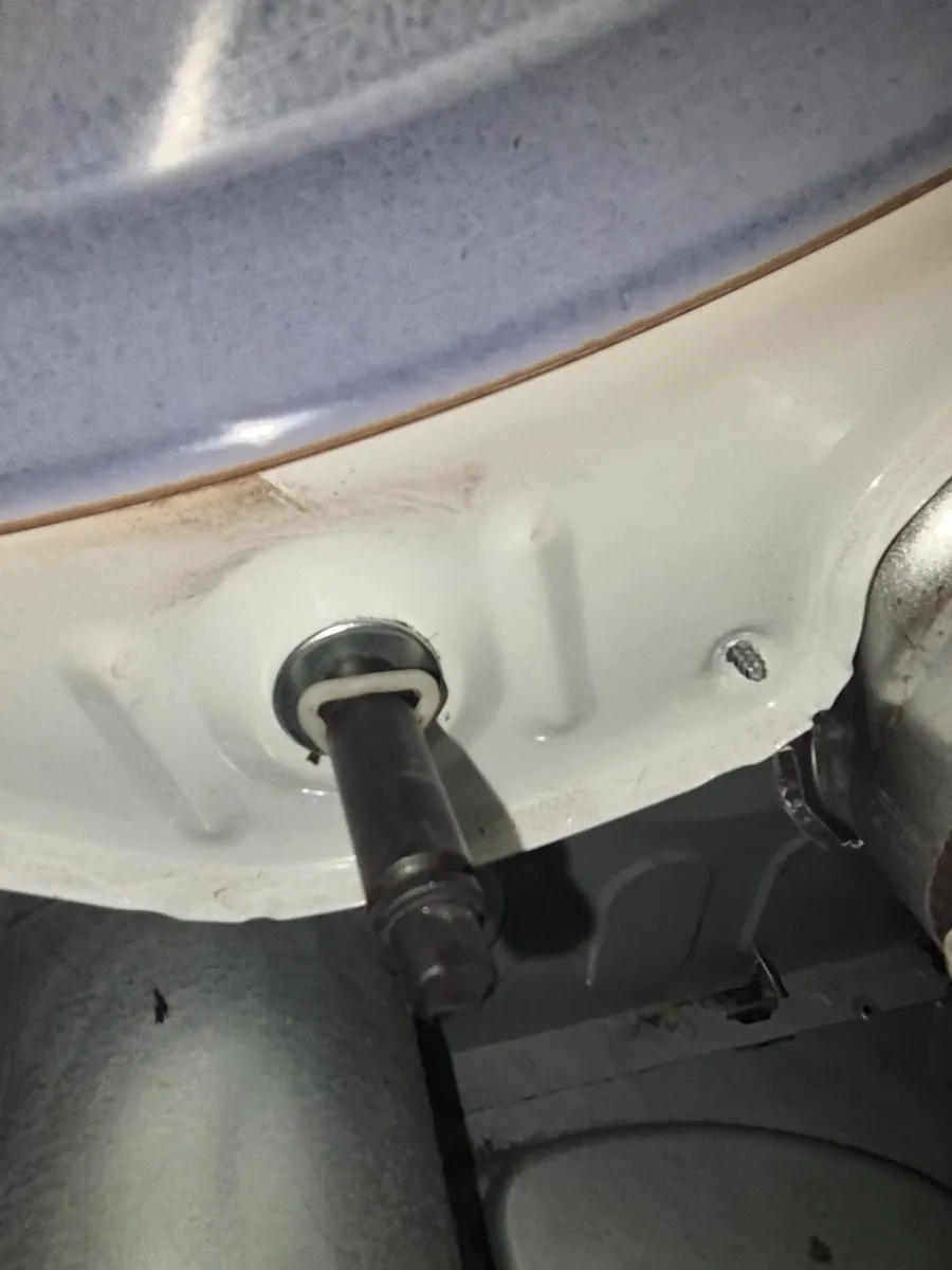 Drum roller shaft on a Samsung dryer after the broken roller was removed
