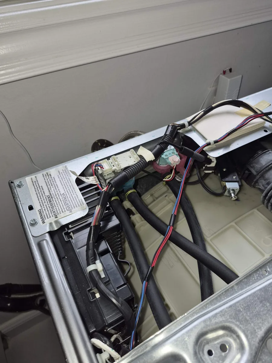 Cold water inlet valve and hoses at the back of a Whirlpool washer